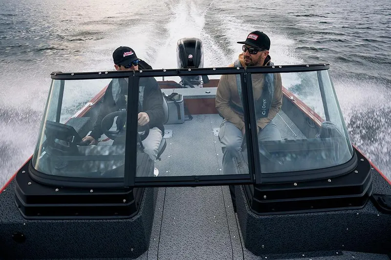 Slide: The Image of Manufacturer Provided Image: 2026 Lund 1800 Explorer Sport boat with two people cruising on water. - 18