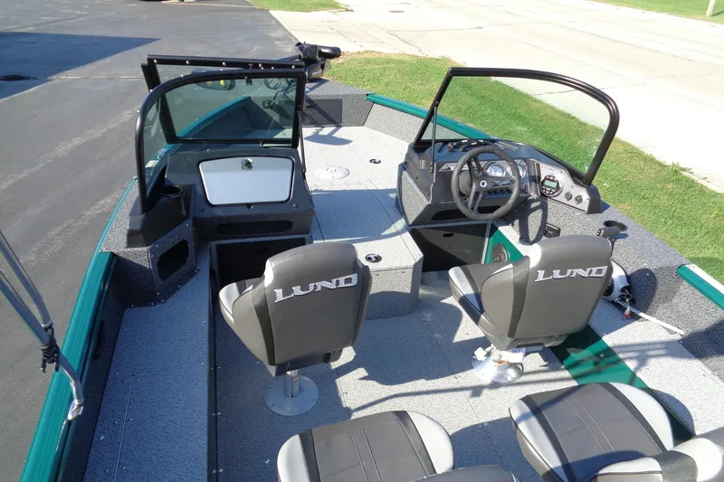 Slide: The Image of 2026 Lund 1800 Explorer Sport boat interior with steering console and seating. - 5
