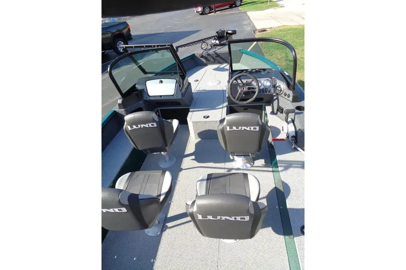 Slide: The Image of 2026 Lund 1800 Explorer Sport boat interior with four seats and steering console. - 6