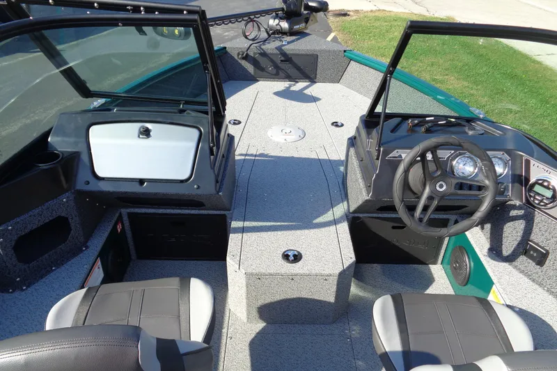 Slide: The Image of 2026 Lund 1800 Explorer Sport boat interior with steering wheel and seating. - 8