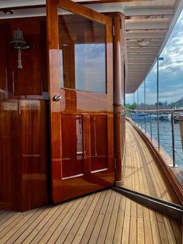 Slide: The Image of 1947 Trumpy Raised Pilot House yacht with wooden deck and open door. - 5