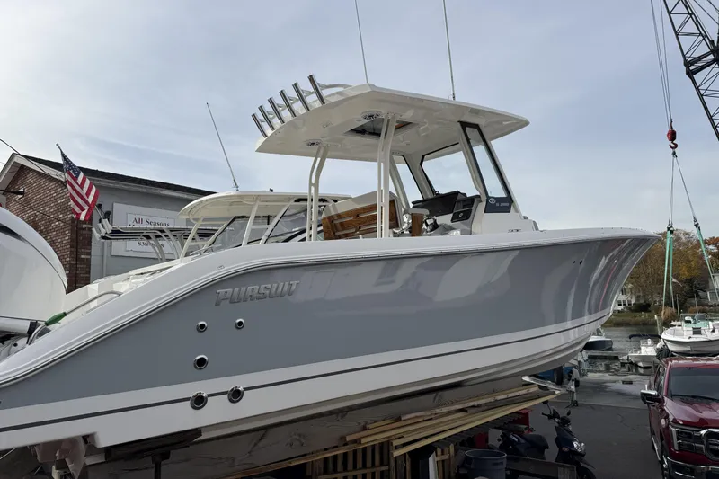 The Image of 2026 Pursuit S 288 Sport boat displayed at a marina, side view. - 0