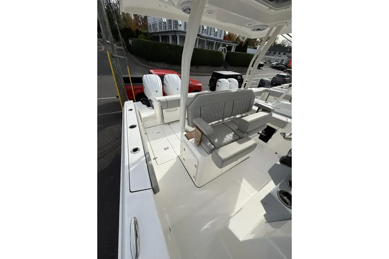 Slide: The Image of 2026 Pursuit S 288 Sport boat interior with cushioned seating and dual outboard motors. - 10