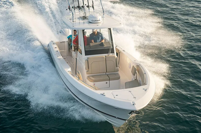 Slide: The Image of Manufacturer Provided Image: 2025 Pursuit S 288 Sport boat cruising on open water, showcasing sleek design and performance. - 11