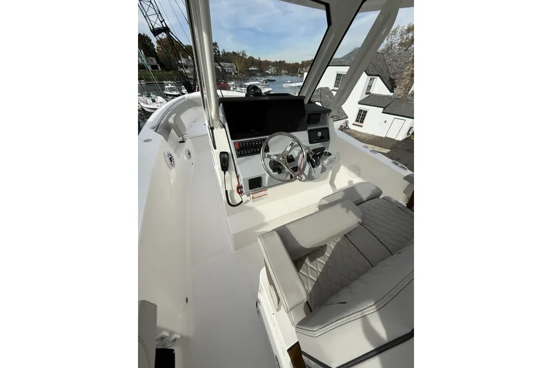 Slide: The Image of 2026 Pursuit S 288 Sport boat cockpit with modern steering and controls. - 8
