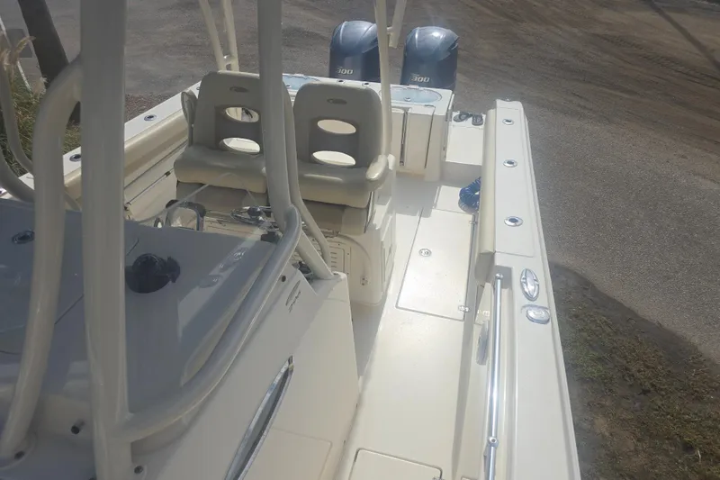 Slide: The Image of 2017 Cobia 296 Center Console boat with dual engines and seating area. - 10
