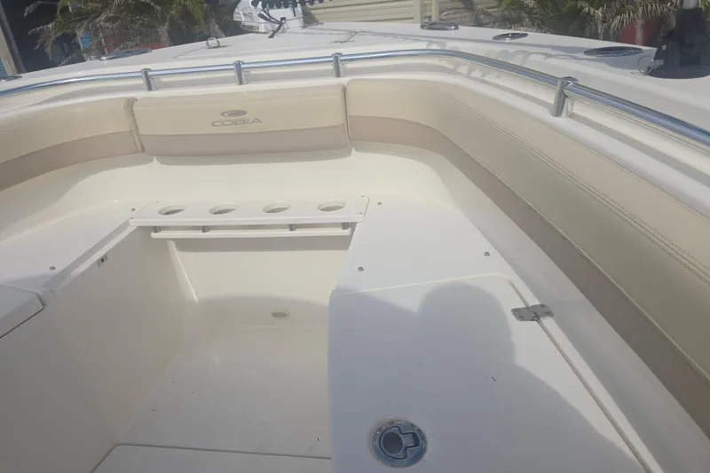 Slide: The Image of 2017 Cobia 296 Center Console boat interior with seating and rod holders. - 14