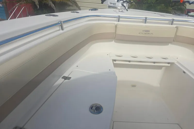 Slide: The Image of 2017 Cobia 296 Center Console boat interior with seating and rod holders. - 15