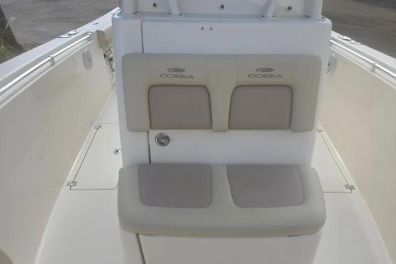 Slide: The Image of 2017 Cobia 296 Center Console boat seating area with beige cushions. - 16