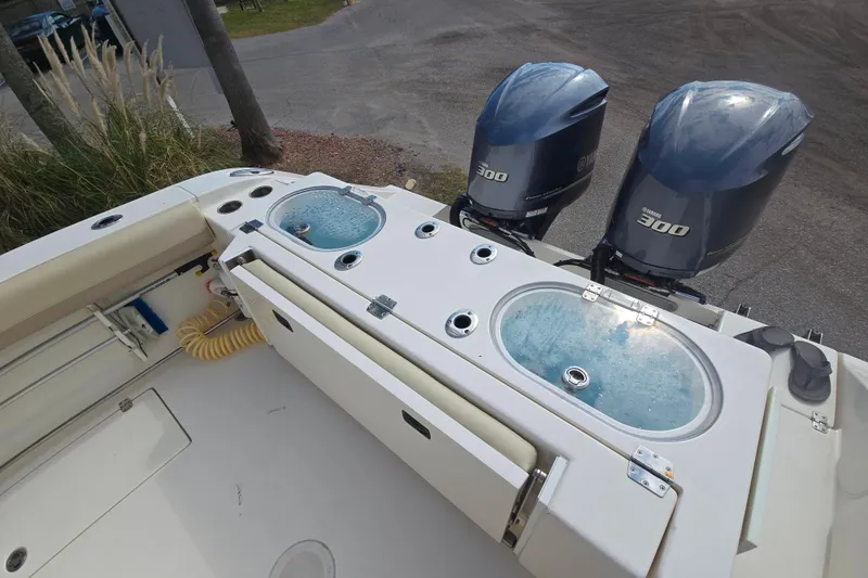 Slide: The Image of 2017 Cobia 296 Center Console boat with dual Yamaha 300 engines and live wells. - 7