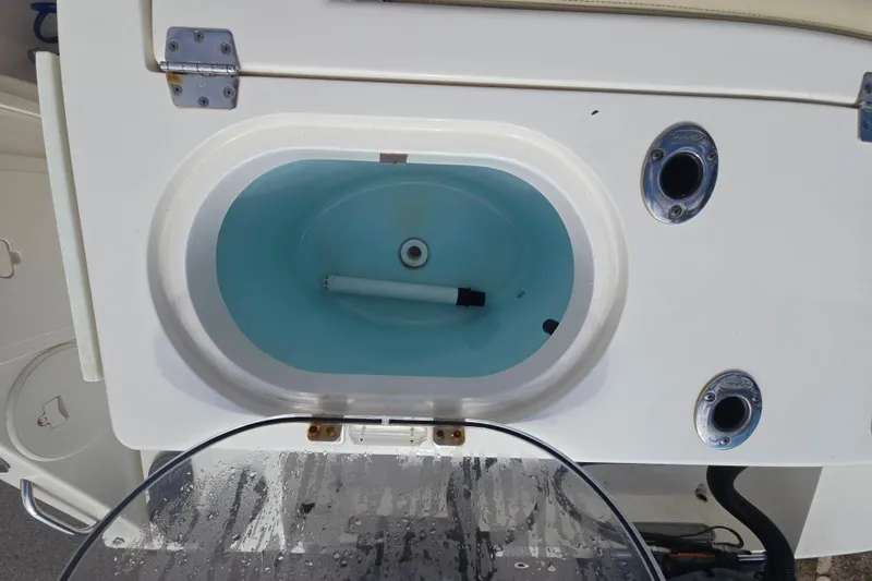 Slide: The Image of Livewell on a 2017 Cobia 296 Center Console boat, featuring a blue interior. - 8