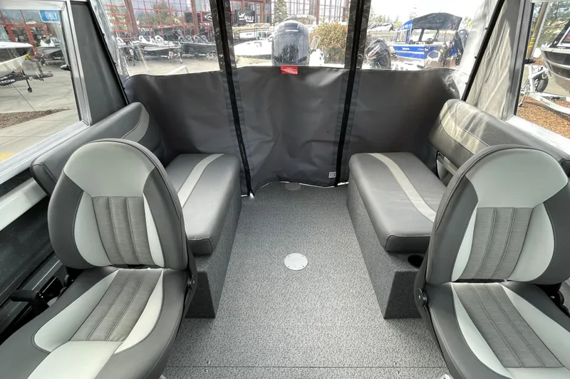 Slide: The Image of Interior of 2024 Spartan 185 Astoria boat with gray seating and carpeted floor. - 14