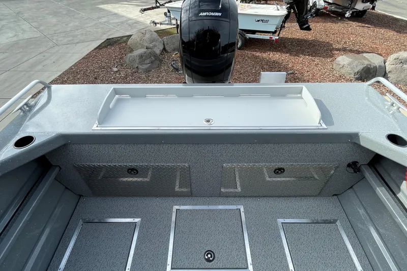 Slide: The Image of 2024 Spartan 185 Astoria boat interior with storage compartments and motor view. - 15