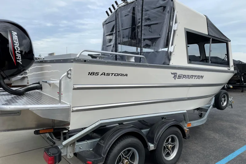 Slide: The Image of 2024 Spartan 185 Astoria boat on trailer with Mercury outboard motor. - 2