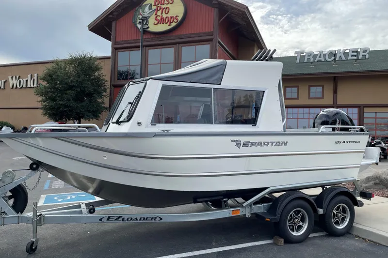 Slide: The Image of 2024 Spartan 185 Astoria boat on trailer outside Bass Pro Shops. - 4