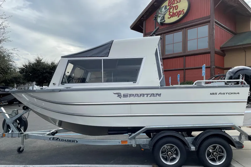 Slide: The Image of 2024 Spartan 185 Astoria boat on trailer outside Bass Pro Shops. - 5