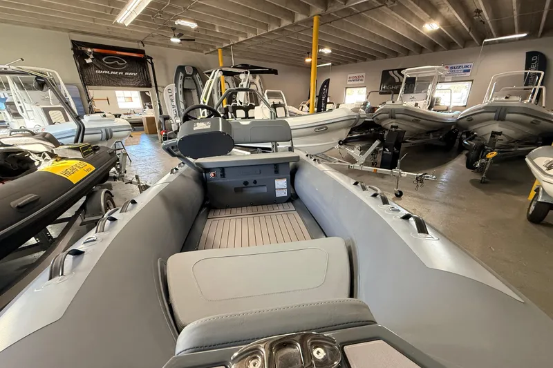 Slide: The Image of 2026 Highfield Classic 400 inflatable boat displayed in a showroom with other boats. - 6