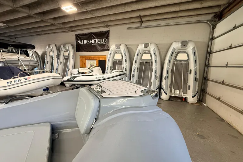 Slide: The Image of Highfield Classic 400 boats in showroom, 2026 model, inflatable design, indoor display. - 7