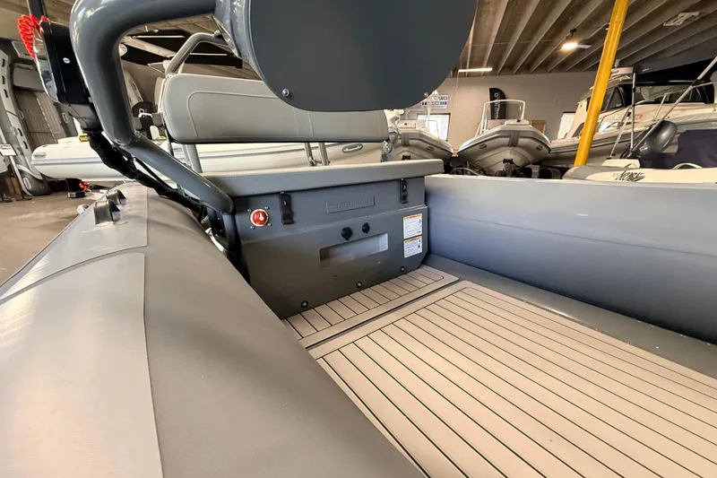 Slide: The Image of 2026 Highfield Classic 400 boat interior with gray seating and wood-patterned flooring. - 8