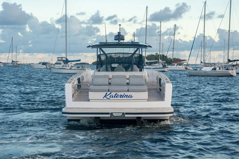 Slide: The Image of Luxury Pardo Yachts 43 (2021) deck with cushioned seating, overlooking serene water. - 9