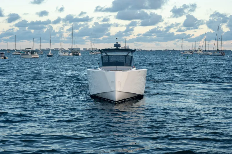 Slide: The Image of 2021 Pardo Yachts 43 cruising in a marina with sailboats in the background. - 7