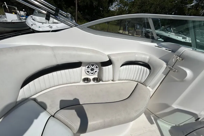 Slide: The Image of 2011 Hurricane SunDeck 2000 OB boat interior with white seating and speaker system. - 14
