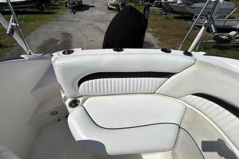 Slide: The Image of 2011 Hurricane SunDeck 2000 OB boat interior with white cushioned seating. - 15