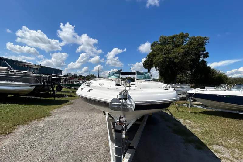 Slide: The Image of 2011 Hurricane SunDeck 2000 OB boat on trailer under clear blue sky. - 18