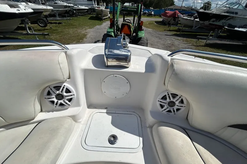 Slide: The Image of 2011 Hurricane SunDeck 2000 OB boat interior with speakers and seating. - 6
