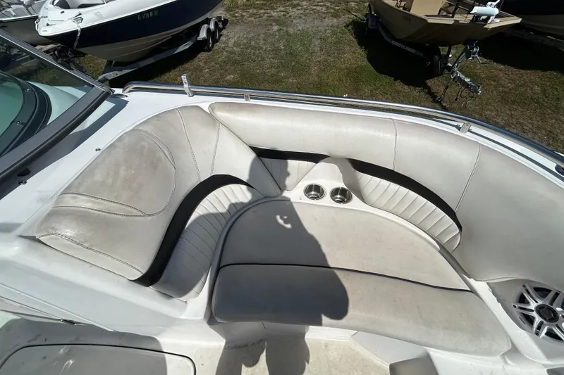 Slide: The Image of 2011 Hurricane SunDeck 2000 OB boat interior with cushioned seating and cup holders. - 7