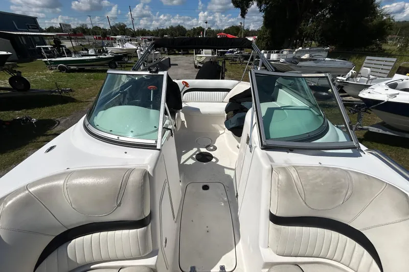 Slide: The Image of 2011 Hurricane SunDeck 2000 OB boat interior with white seating and open deck layout. - 9