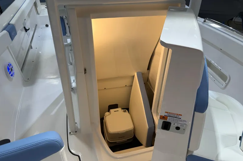 Slide: The Image of 2026 Robalo R222 Explorer boat interior at a showroom, featuring seating and console. - 20