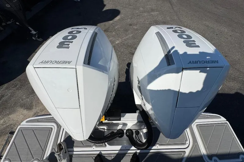 Slide: The Image of Twin Mercury outboard engines on a 2026 Monterey Elite 30 OB boat. - 11