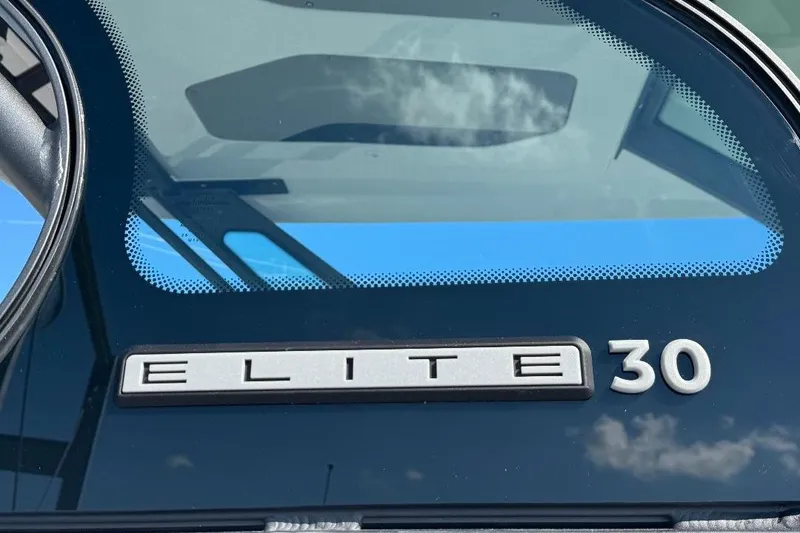 Slide: The Image of 2026 Monterey Elite 30 OB boat logo on windshield with sky reflection. - 13