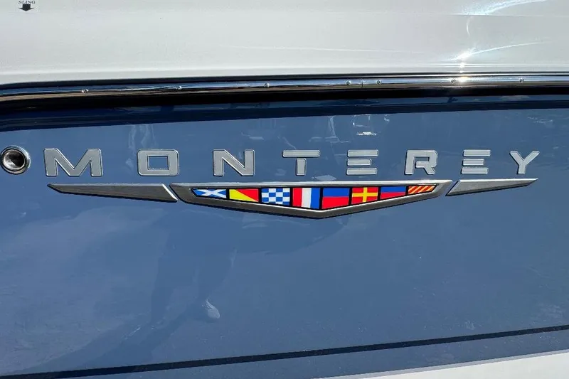 Slide: The Image of 2026 Monterey Elite 30 OB boat logo with nautical flags on blue background. - 15