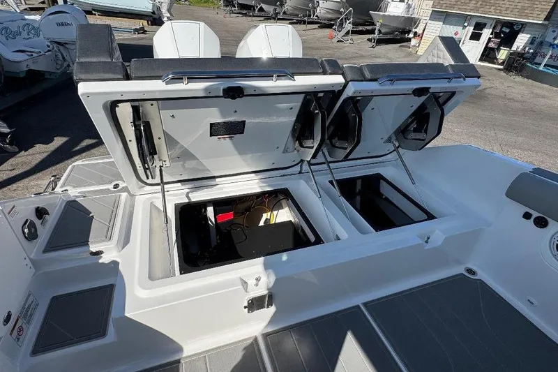 Slide: The Image of Open storage compartments on a 2026 Monterey Elite 30 OB boat deck. - 5