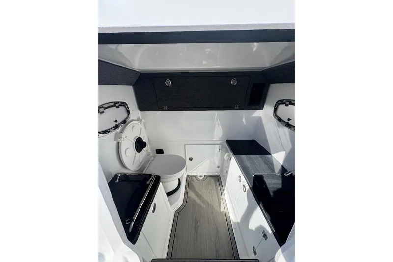 Slide: The Image of Interior of 2026 Monterey Elite 30 OB boat, featuring modern cabinetry and compact design. - 8