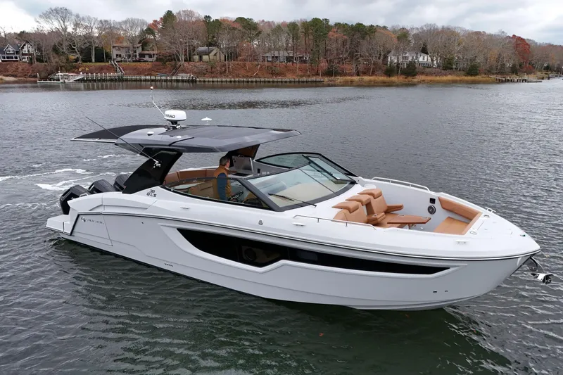 The Image of 2026 Cruisers Yachts 38 GLS OB on a serene lake, showcasing sleek design and luxury. - 1