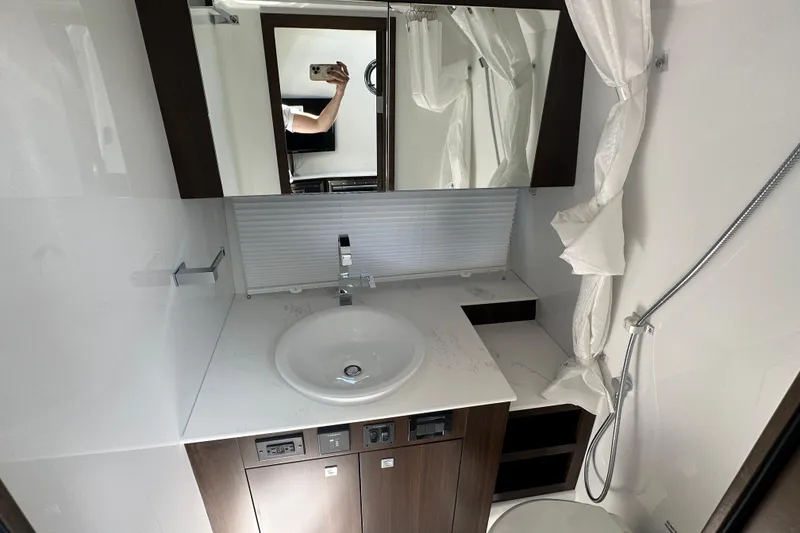Slide: The Image of Bathroom interior of 2026 Cruisers Yachts 38 GLS OB, featuring modern sink and shower. - 13