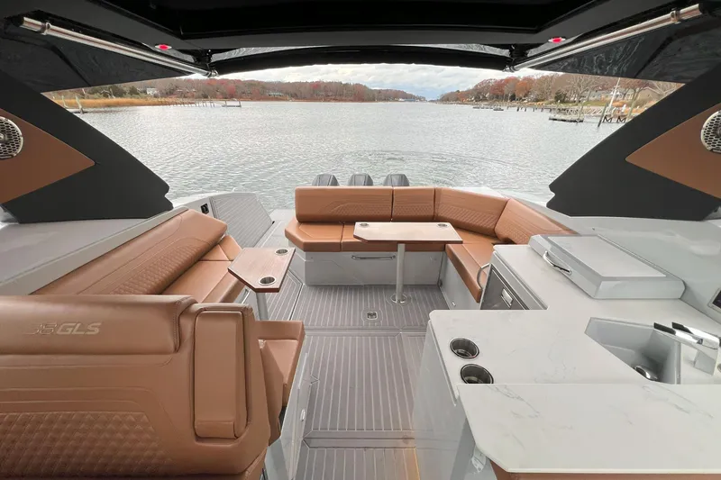Slide: The Image of Luxurious 2026 Cruisers Yachts 38 GLS OB interior with elegant seating and scenic water view. - 14