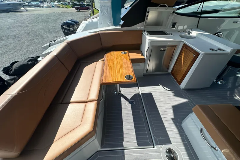 Slide: The Image of Luxurious seating and kitchenette on 2026 Cruisers Yachts 38 GLS OB boat. - 5