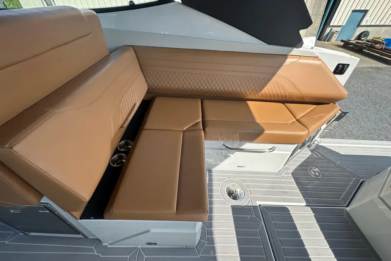 Slide: The Image of Luxurious tan seating on 2026 Cruisers Yachts 38 GLS OB, featuring cup holders and sleek design. - 7