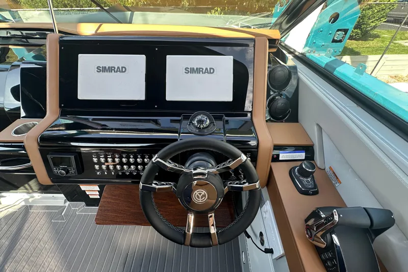 Slide: The Image of 2026 Cruisers Yachts 38 GLS OB helm with dual Simrad displays and modern controls. - 10
