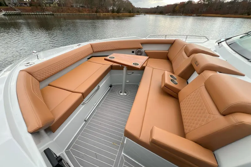 Slide: The Image of Luxurious seating area on 2026 Cruisers Yachts 38 GLS OB, featuring tan leather upholstery. - 17