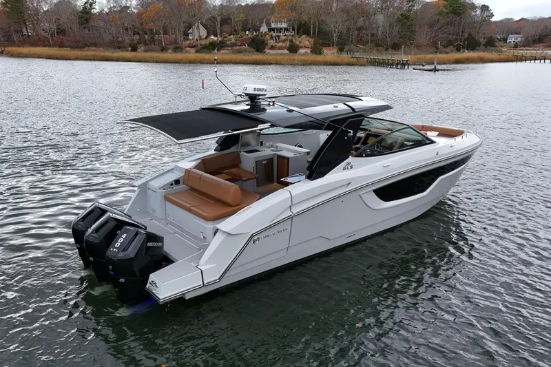 Slide: The Image of 2026 Cruisers Yachts 38 GLS OB on serene water, showcasing sleek design and powerful engines. - 3