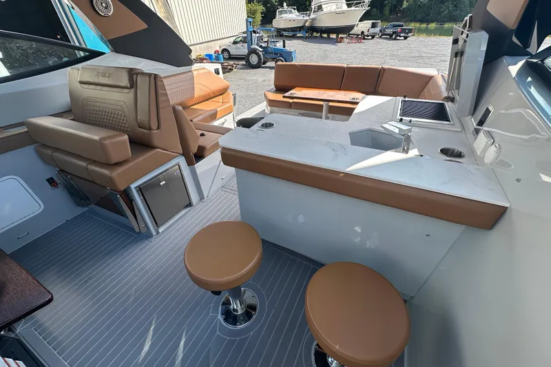 Slide: The Image of 2026 Cruisers Yachts 38 GLS OB interior with seating, bar stools, and outdoor amenities. - 8