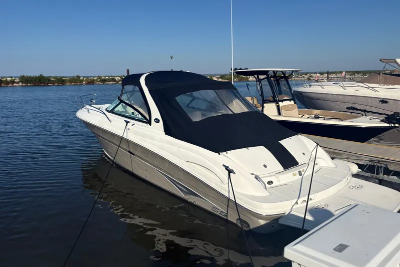Slide: The Image of 2005 Sea Ray 290 Sun Sport boat docked on calm water. - 10