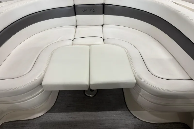 Slide: The Image of 2005 Sea Ray 290 Sun Sport boat seating with white and gray upholstery. - 11