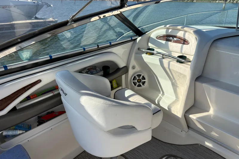 Slide: The Image of Interior of 2005 Sea Ray 290 Sun Sport boat with white seating and dashboard. - 12