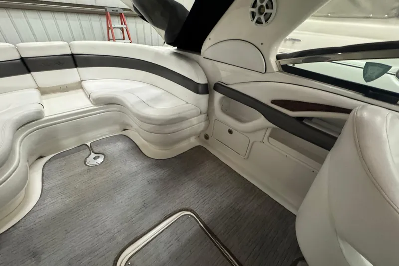 Slide: The Image of Interior of 2005 Sea Ray 290 Sun Sport boat with white seating and gray flooring. - 15